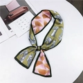 Green and pink animal print skinny scarf tied elegantly on a white table - Dark Green Horse (8)