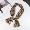 Houndstooth pattern silk scarf in brown and black with pink borders tied in a bow - Houndstooth Khaki Edge