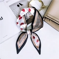 Elegant heart print skinny silk scarf styled on handbag with houndstooth pattern accents - Red Heart