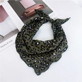 Dark green leopard print triangle scarf with wavy edges on a white tabletop - Dark Green Leopard Print