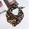 Elegant leopard print silk scarf for women in classic brown and black tied on a magazine - Golden Yellow Leopard