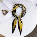 Leopard print patchwork silk scarf in yellow and black, knotted on a white table - Bright Yellow Leopard Print (3 Twill Bright Yellow)
