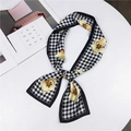 Houndstooth pattern silk scarf with yellow floral print shown on a magazine setup - Floral Grid Black