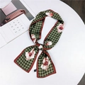 Long silk scarf with green houndstooth and pink floral patterns tied in a knot - Floral Grid Green