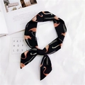 Close-up of black skinny scarf with pink flamingo print on white textured fabric - Black Flamingo