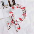 Detail of a white silk scarf with red flamingo prints styled on an open magazine - Beige Flamingo