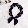 Detail of navy blue flamingo print skinny scarf tied in a stylish knot on white fabric - Navy Flamingo