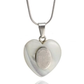 Macro detail of silver heart pendant with shell inlay and religious engraving - Milagroso De Buga Cross Style With Necklace / Silver
