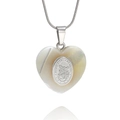Macro shot of shell heart pendant with Saint Michael engraving on silver snake chain - San Miguel Arcangel Style With Necklace / Silver
