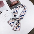 Pink and white striped long silk scarf with blue heart prints on a white table - Pink Heart Stripe