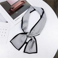 Elegant black and white striped long silk scarf tied on a minimalist white table - Vertical Stripes White