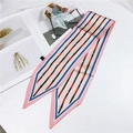 Narrow pink and blue silk twilly scarf with gold buckle pattern flat lay on white surface - Belt Pattern Pink