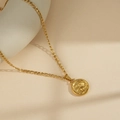 Gold Scorpio coin pendant necklace with vintage Figaro chain for men on beige backdrop - Scorpio