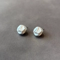 Macro detail of silver irregular geometric cube earrings with textured hammered finish - Silver