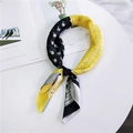 French style floral silk scarf in black and yellow contrast pattern on a white table - Black and Yellow