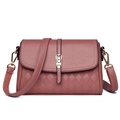 Detail of mauve faux leather handbag featuring litchi grain and quilted diamond stitching - Dusty Pink