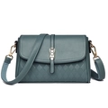 Detail view of greyish-blue textured leather handbag with quilt pattern and gold clasp - Grey Blue