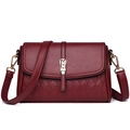 Detailed shot of dark red leather bag with litchi grain flap and quilted rhombus texture - Fuschia