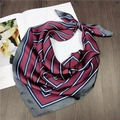 Detail of striped silk square scarf with glossy texture on a minimalist wooden surface - 16 Striped Wine Red