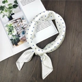 Detail of a creamy white satin square scarf with navy blue polka dots on dark wood - 60x60cm / Polka Dot Cream White