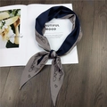 Detail of navy and khaki knotted silk scarf with cursive letters and heart print - Navy Letter Print