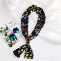 Floral print long skinny scarf styled with sunglasses and magazine on white fabric - Black Floral
