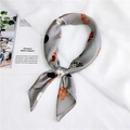 Satin neck scarf with gray base, vibrant floral patterns and blue dots in a knotted style - Grey Leaf