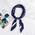 Close-up of navy blue polka dot silk scarf with stylish sunglasses on a white background - Navy Blue