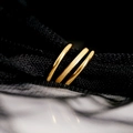 Macro view of gold titanium rings set featuring polished and matte sandblasted finishes - US 7 / Gold