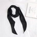 Flat lay of a black satin skinny scarf with a magazine on a white fabric background - Black