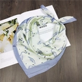 Green silk-like square scarf with purple border and swan prints on a magazine - 3 Flamingo Green
