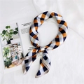 Macro detail of checkered silk scarf in orange and navy blue on an elegant lifestyle background - 70cm / Orange Plaid