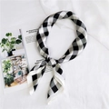 Close-up of a classic black and white checkered chiffon square scarf tied in a stylish knot - 70cm / Black Checkered