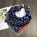 Detail of silk scarf with navy horse print and contrast borders on a magazine - 22 Little Horse Navy Blue