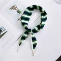 Green and navy blue striped narrow satin twilly scarf folded on a magazine page - Three Green Stripes
