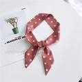 Elegant dusty pink polka dot hair scarf tied in a bow on a white magazine background - Pink Wide Polka Dot