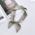 French vintage khaki polka dot silk scarf tied in a bow on a white desk setup - Khaki Small Polka Dot