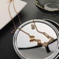 Elegant 18k rose gold butterfly necklace with pearl detail on a reflective mirror surface - Rose Gold