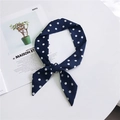 Dark blue silk scarf with white polka dots tied neatly on a clean white backdrop - Navy Wide Polka Dot