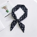 Elegant black silk scarf with white polka dots tied in a bow on a stylish magazine - Black Wide Polka Dot