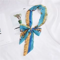 Detail of silk scarf tied in a bow featuring vintage horse and buckle print patterns - 35 Blue Horse Pattern
