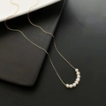 Elegant gold titanium necklace with seven natural white pearls arranged in a delicate arc - Gold(04-K7)