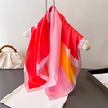 Detail eines farbenfrohen Seidenschals mit Farbverlauf-Design und Satin-Oberfläche - Rot