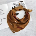 Caramel yellow silk scarf with geometric patterns tied on a stylish magazine - Small Stripe Brown