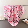 Detail of pink leopard print silk scarf draped on a metal stand with elegant texture - Pink
