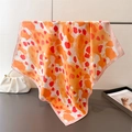 Detail of silk-like leopard print scarf showing the orange pattern and soft draping texture - Orange