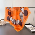 Detail of orange silk scarf with abstract geometric patterns and smooth satin texture - Orange