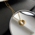 Polished gold geometric circular pendant necklace on minimalist mirror surface background - Gold