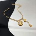 18K gold plated titanium steel chain bracelet with rocking horse and dollar sign charms - Gold