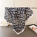 Detail of silk-like square scarf featuring black and white geometric floral patterns - Square / Black